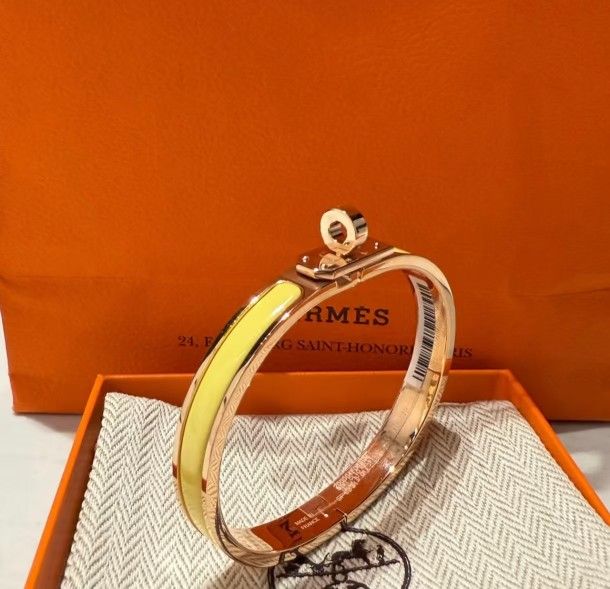 Hermès' new enamel bracelet, made of rose gold with yellow accents.