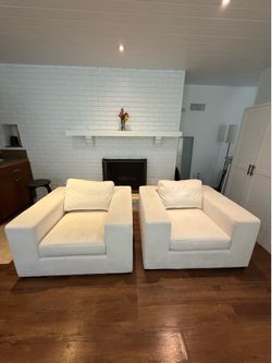 Pair of white arm chairs