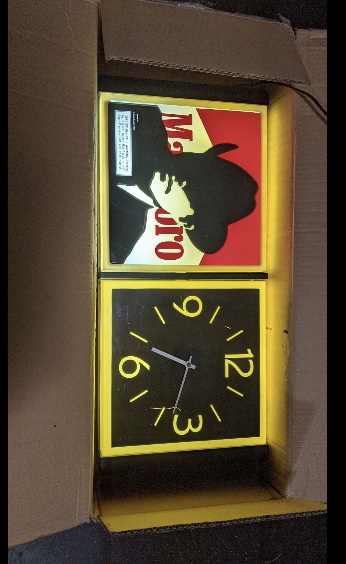 1992 Marlboro Man clock 26x12x4-in Lights up. Unsure about clock working.