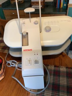 This is a Singer Magic Steam Press Model CSP1 designed for crafting and laundry use.The unit features multiple fabric settings including Nylon, Silk, 