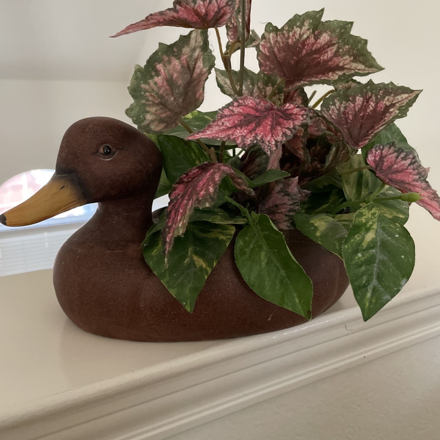 A Ceramic Brown Duck Decor With Fake  Plants 10 Inches Long