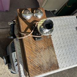 Old telephone with working hand crank/bells. Would make a nice item for your man cave or for the kids to play with.   Could use a little cleanup/love 