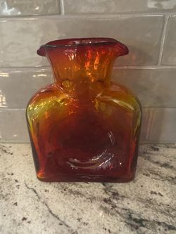 Vintage Blenko Glass Company hand blown tangerine water bottle.