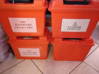 Large orange plastic container, Black plastic shell cases and plastic organizer kits.  16 Black cases, 4 orange cases and 36 organizer cases.