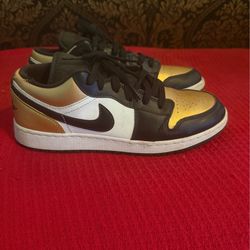 Nike Air Jordan 1 Low "Gold Toe" sneakers.