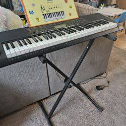 Casio keyboard with stand and music book for kids