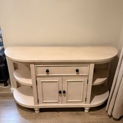 Light wood rounded console table