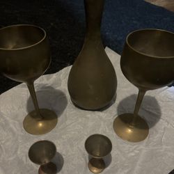 Brass decorative vase, two brass wine goblets and two small goblets.