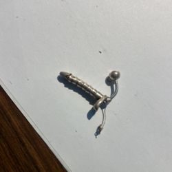 silver phallic belly button bar with purple gem