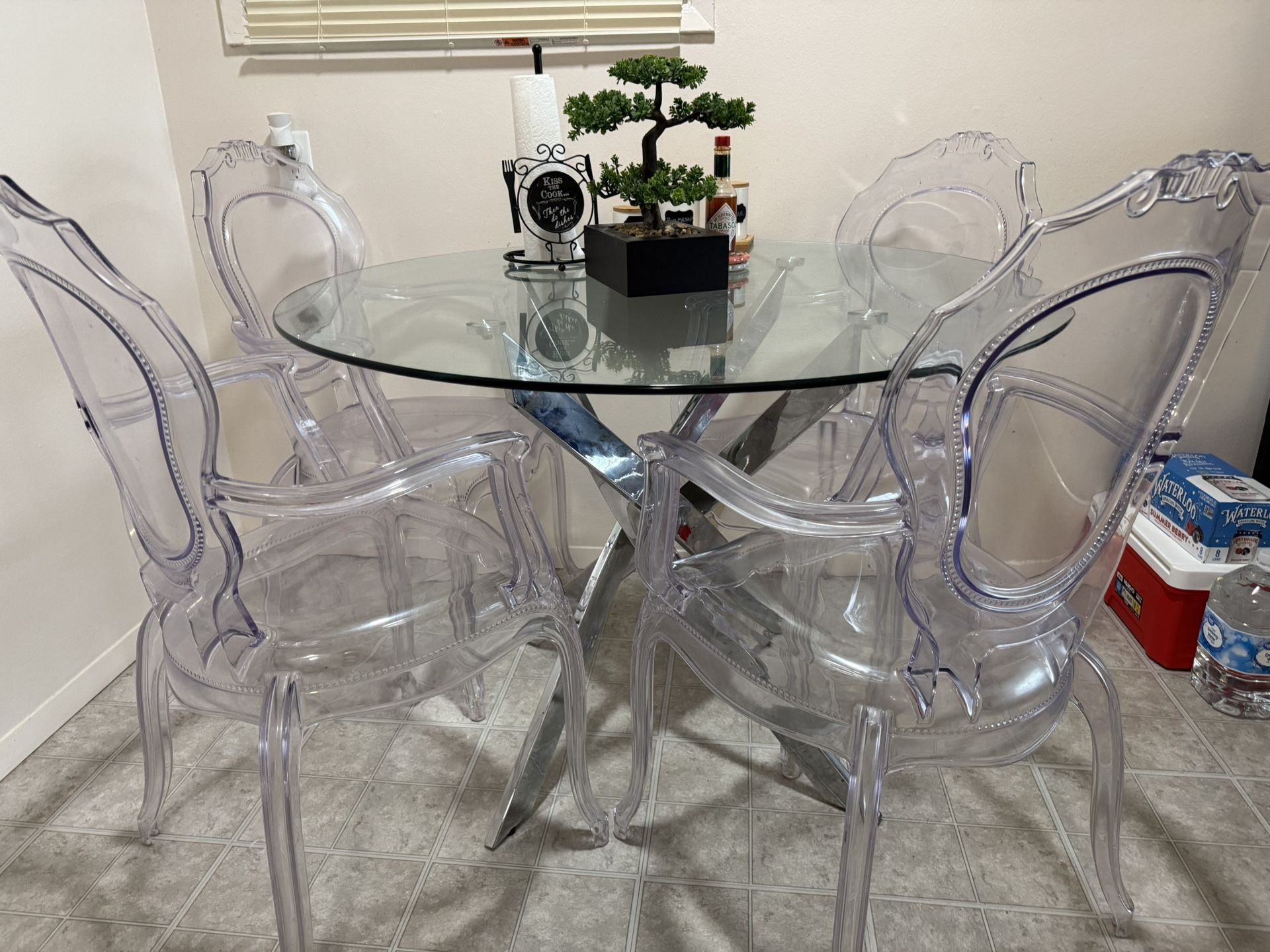 Glass top dining table with four chairs