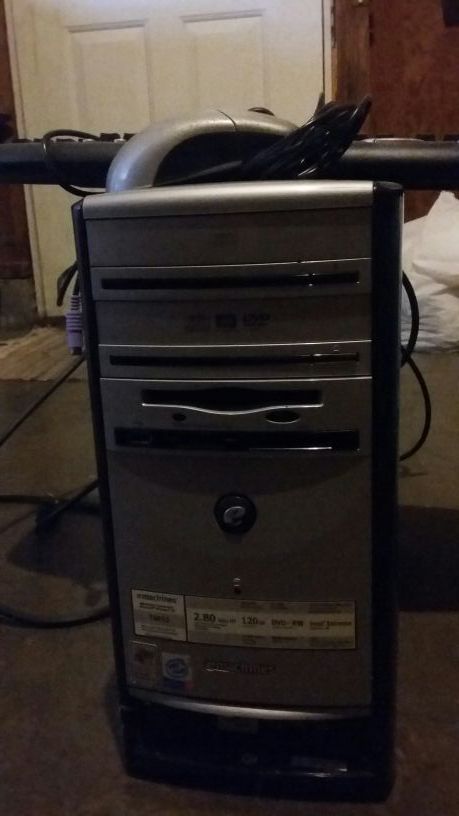Computer tower with keyboard and mouse.