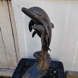 Bronze statue mother dolphin and baby