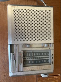 Soundesign AM/FM portable radio, probably from the late 1960s to 1970s. The brushed metal face, slide controls, and analog tuning dial