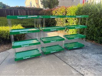 Three plastic shelves that has the Seagram’s logo