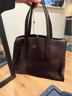 Coach Charlie Carryall in a deep oxblood leather bag/ w wallet