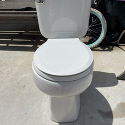 Toilet in good condition, very clean, measures 16 inches high