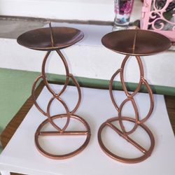 pair of copper-painted metal pillar candle holders with geometric design