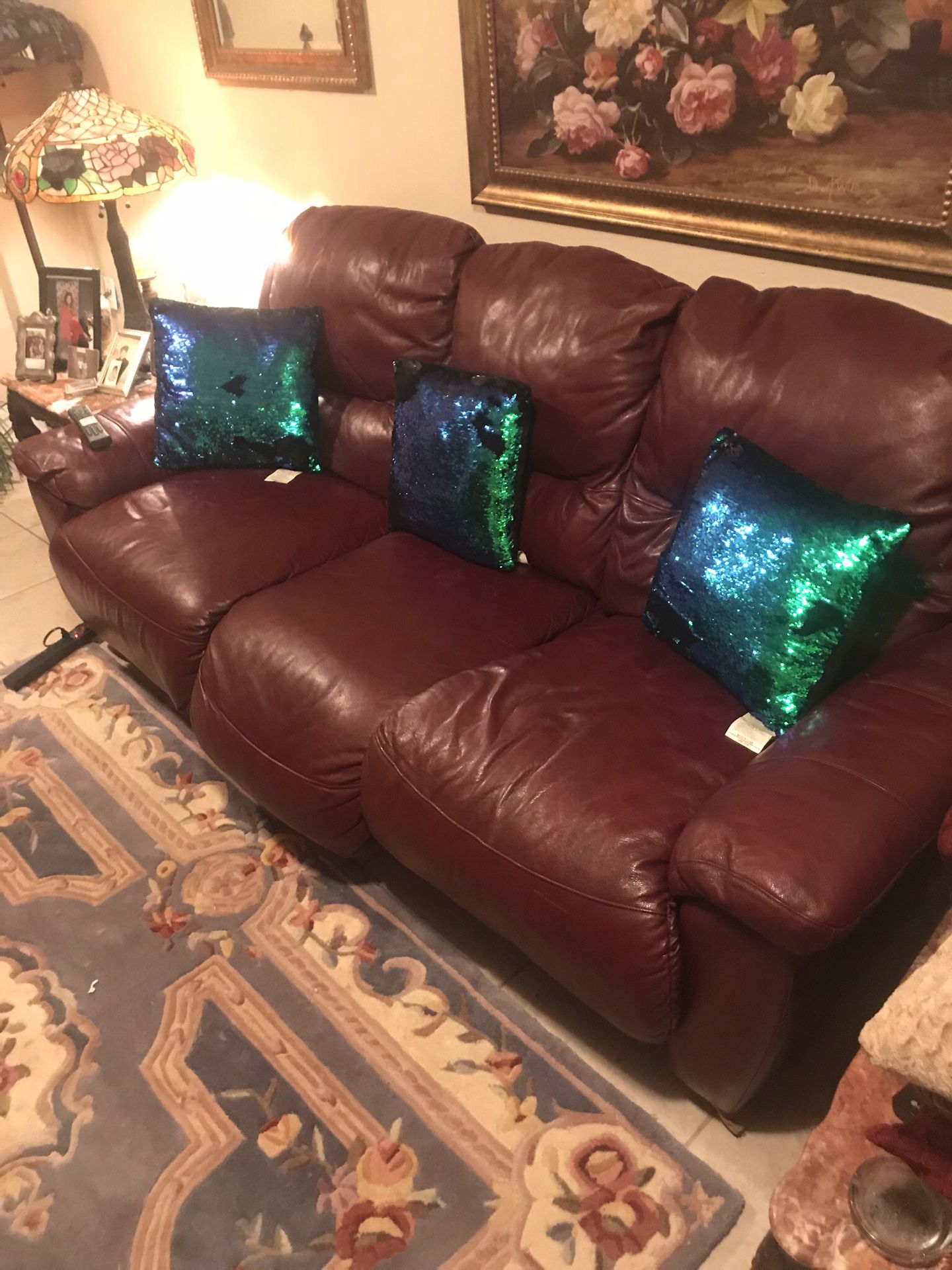 Two red couches with recliners on both ends of each couch