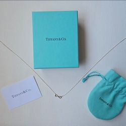 Tiffany and Co brand NEW infinity symbol necklace. Sterling silver fancy jewelry with new gift box