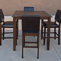 Brown Wooden dining table with 4 matching faux leather chairs 
Table  dimensions-36" T x W x 39"1/ x 39" 1/2 