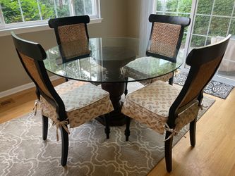 Glass top dining room table with 4 black chairs