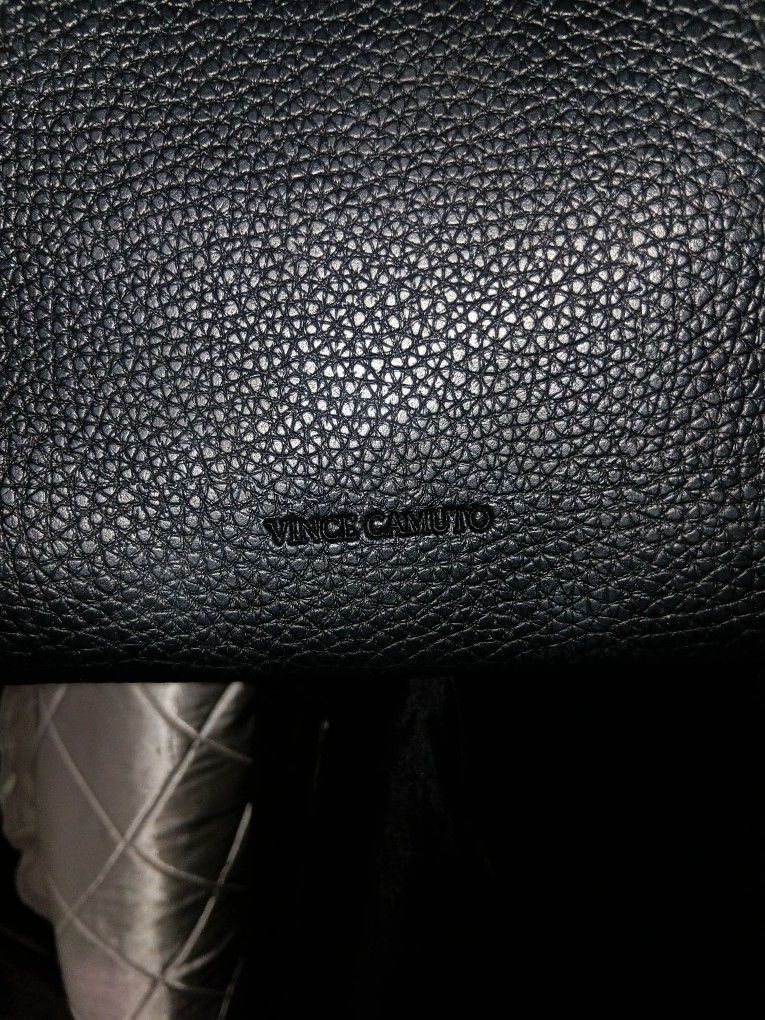 This is a black pebbled leather Vince Camuto tote bag.