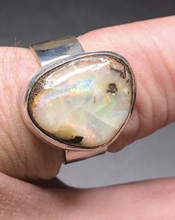 Australian Boulder Opal multicolored flash, on white. Solitaire solid 925 sterling silver ring stone is 10.3ct 16x13x5.4mm size 7 USA