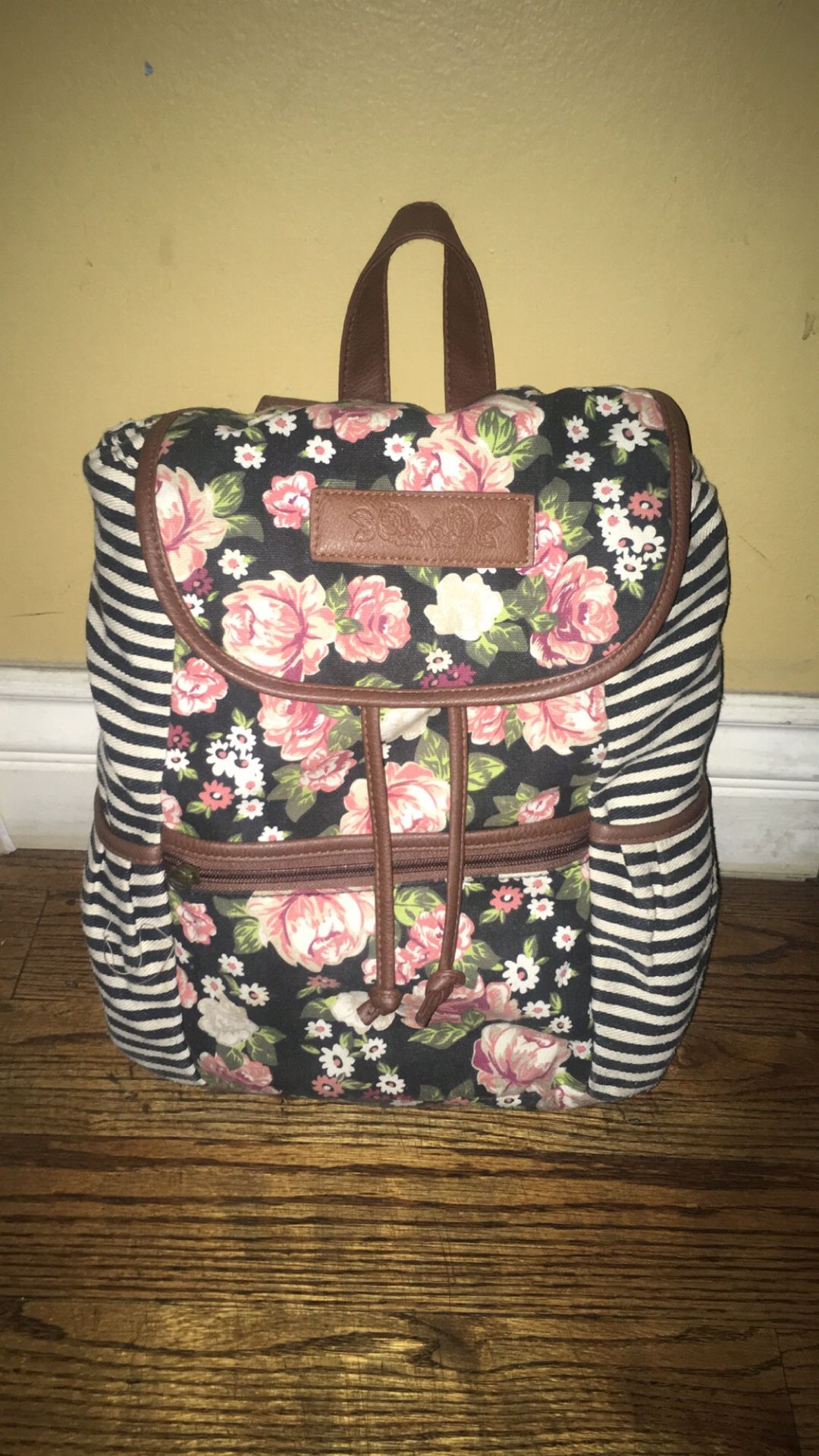 Pink floral backpack with stripes on side
