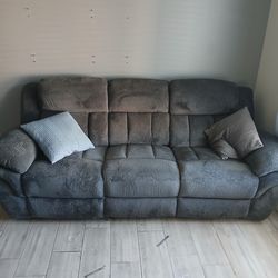 Grey/green double recliner couch.