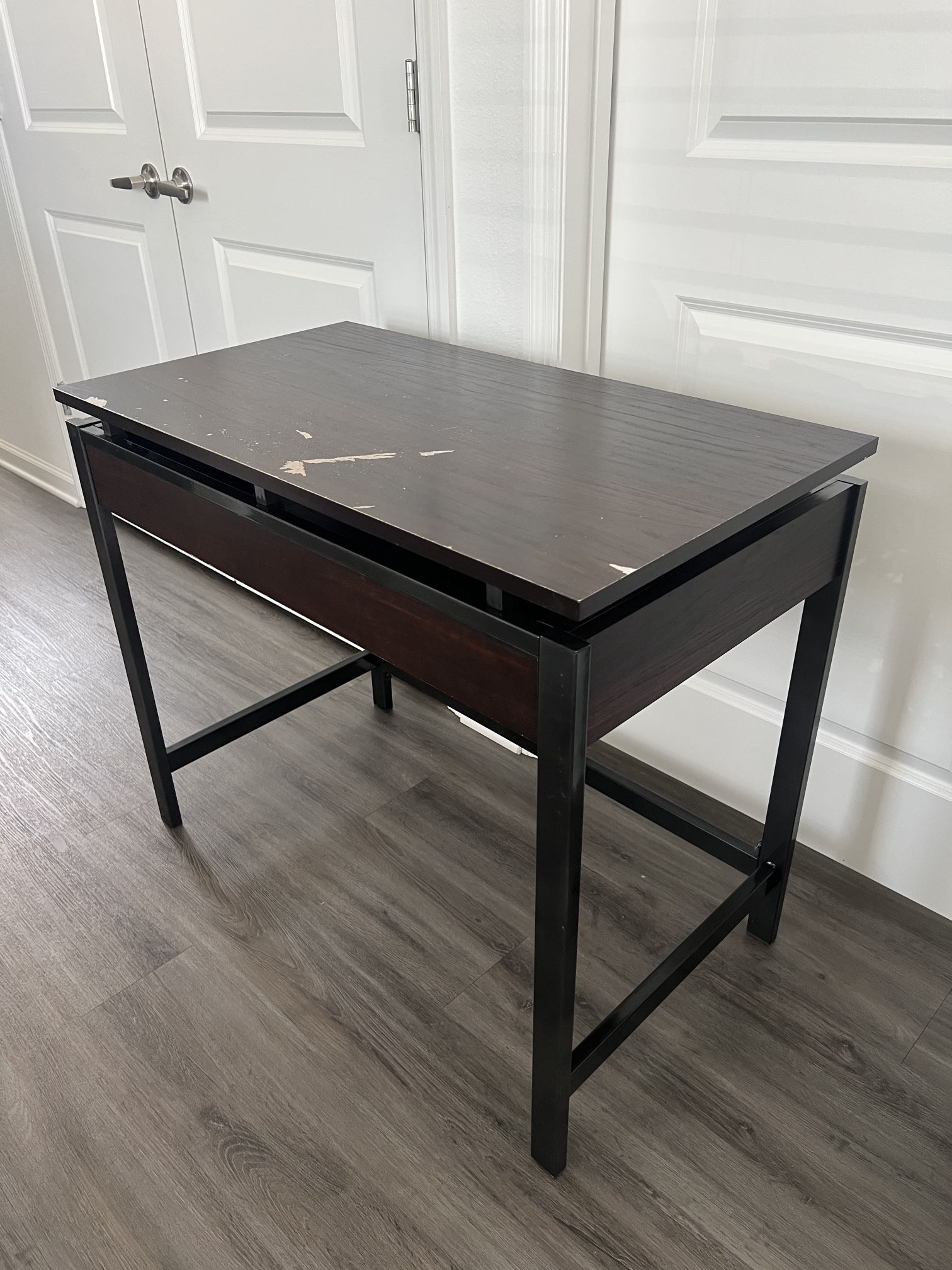 Brown wooden desk with metal framing