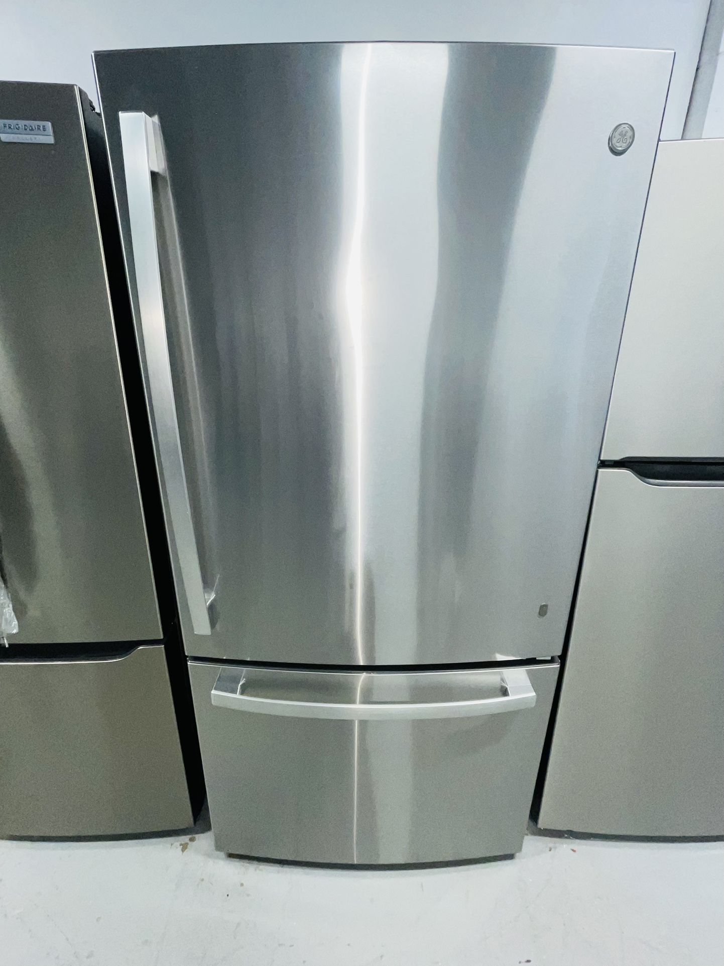 GE stainless steel refrigerator 33X69X30 with a receipt for a 90-day warranty