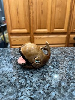 Vintage 1970’s Ceramic Ashtray “Smiling Whale”.  The lighting is bad in the picture there are no white spots.  Size approximately 2 1/2 inches tall an