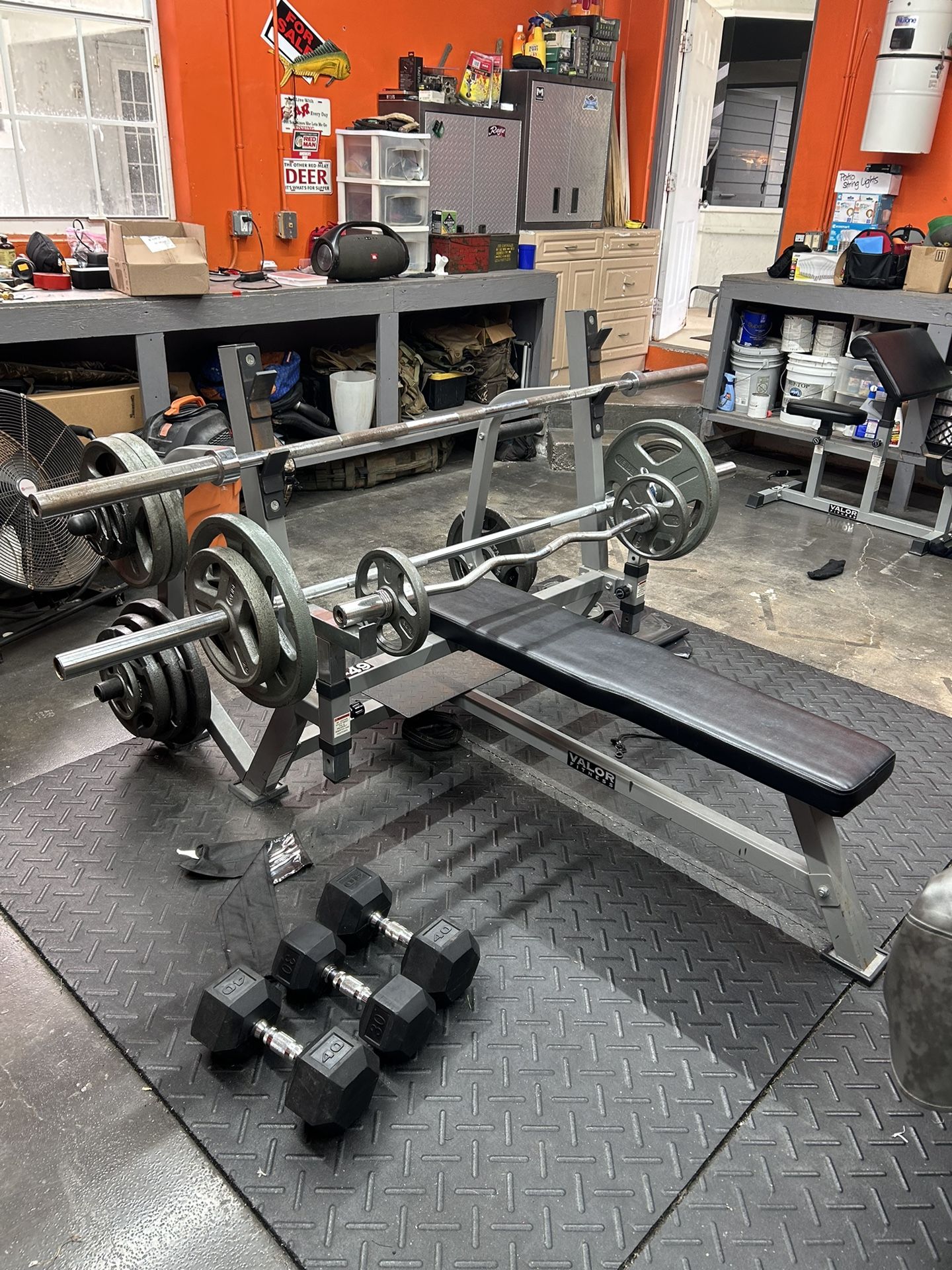 weight bench 500+ lbs, dumbbells, preacher curl machine, squat rack.