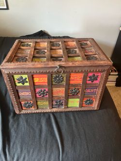 World Market medium wood and fabric storage chest.