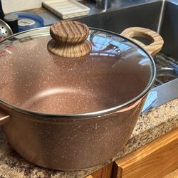 non-stick aluminum pot with a glass lid and wood-effect handles. 