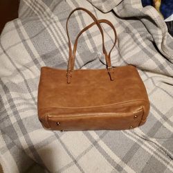 Light Brown Urban Expessions Purse.  Inside  is black and white stripped .  There is some wear on the  bottom.