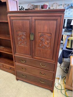Asian-style armoire featuring intricate carved dragon motifs on the doors and brass hardware - 36” x 20” x 60.5 - Excellent Condition