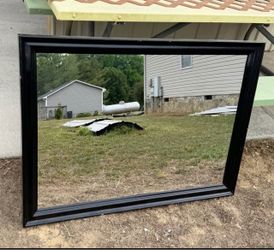 Rectangular wall mirror with a glossy black framed finish
