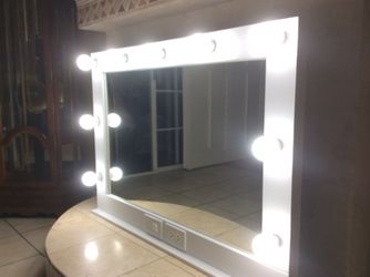 Vanity mirror with electric outlet