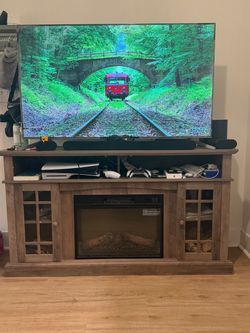Wooden entertainment center with electric fireplace