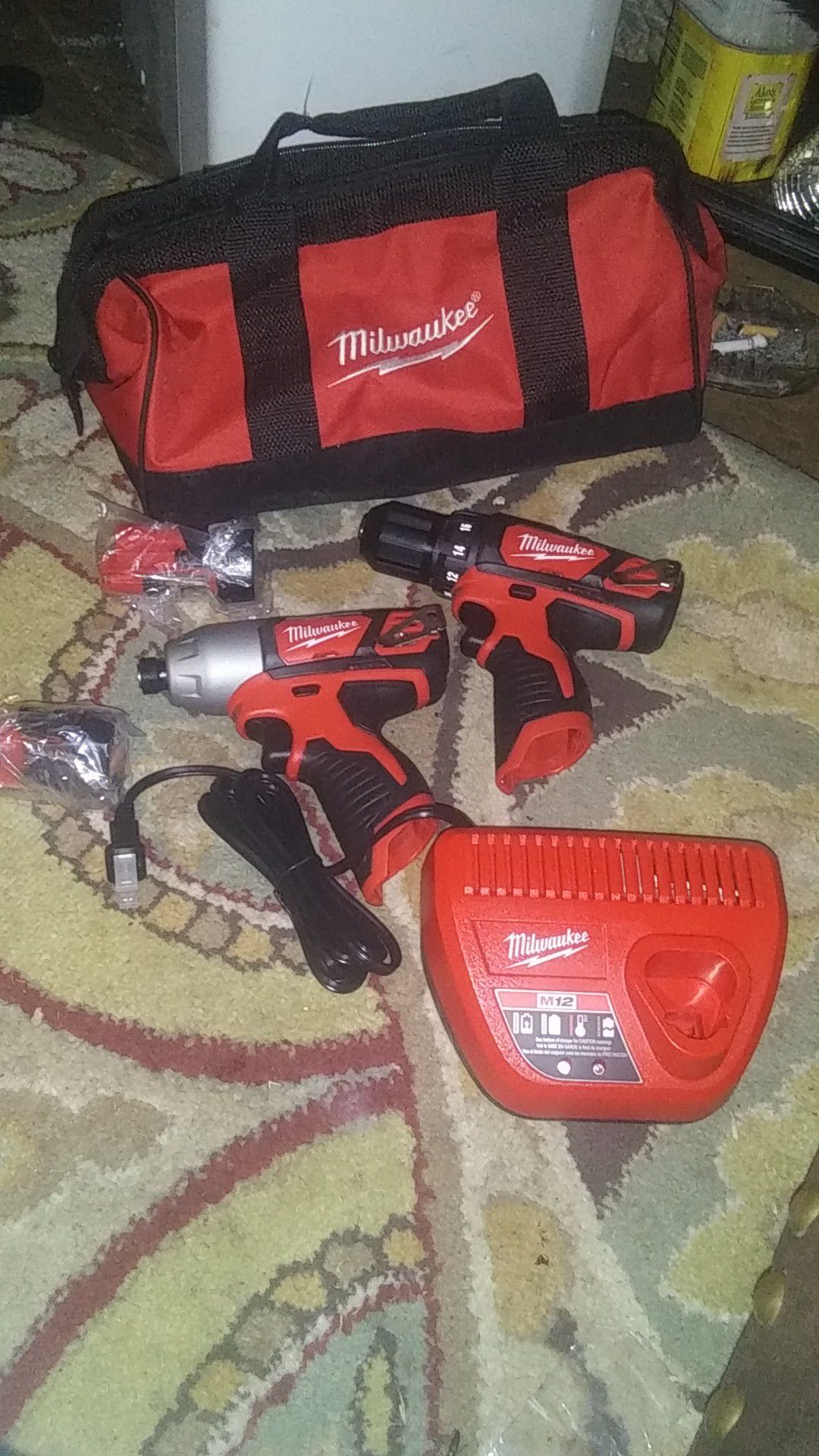 Milwaukee M12 3/8 hammer drill / driver and 1/4 driver with two batteries and charger brand new never been used
