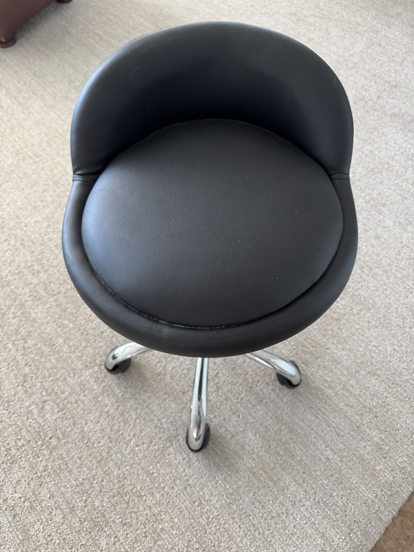 Leather and chrome swivel rolling stool