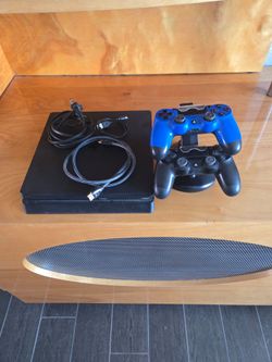 PlayStation 4, 500GB, with Two Controllers and charging stand.