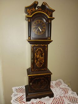 Beautiful tall battery operated clock with multiple storage areas for keys and other accessories