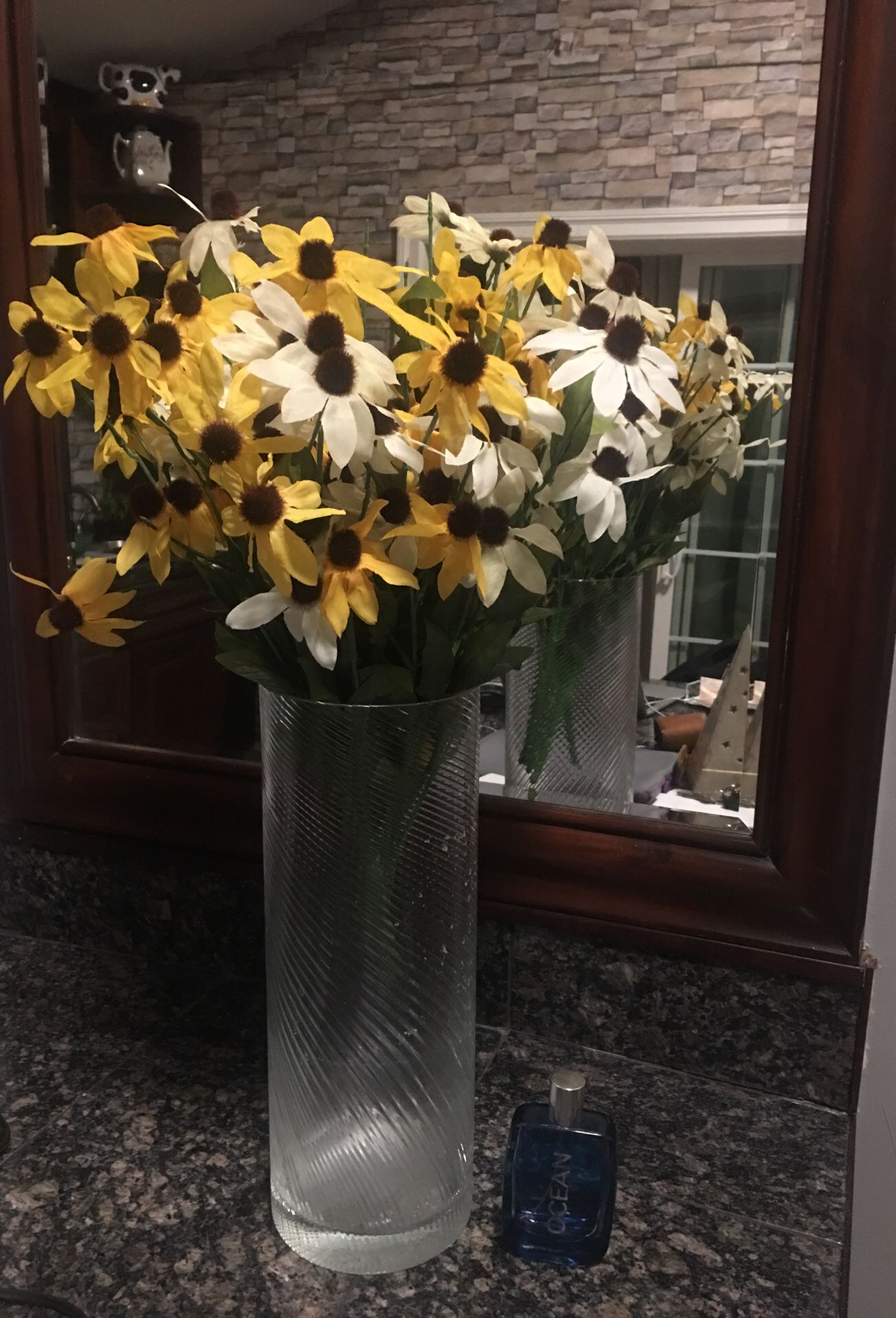 Tall Glass Vase with artificial flowers.