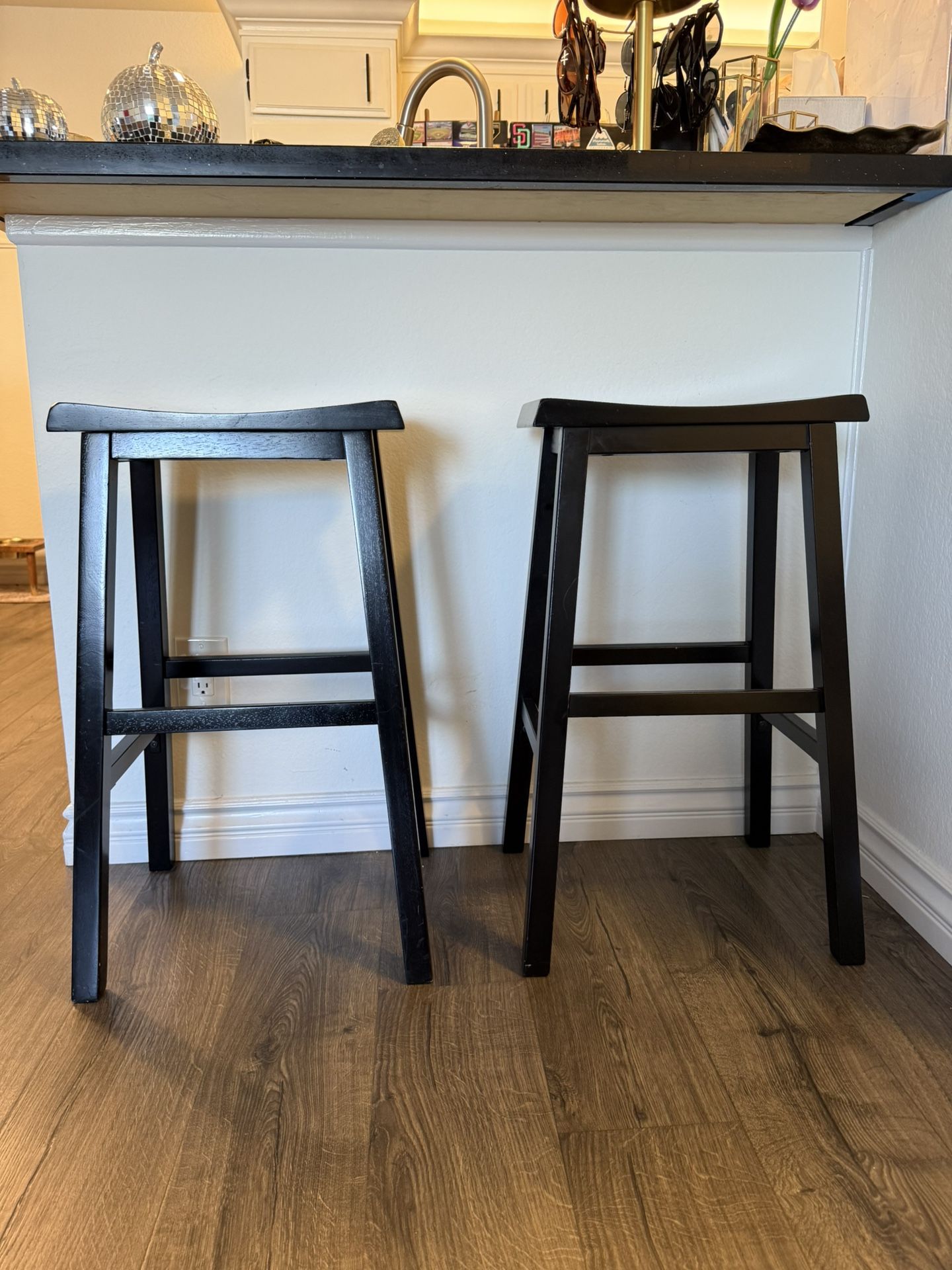2 black solid wood stools