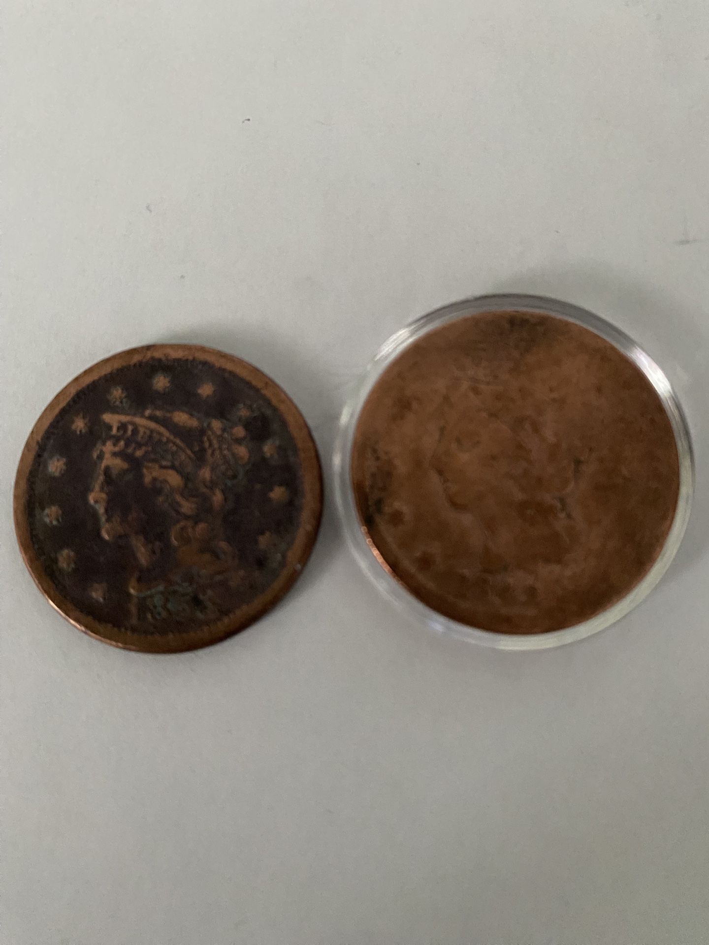 two one-cent coins 1843 And 1853