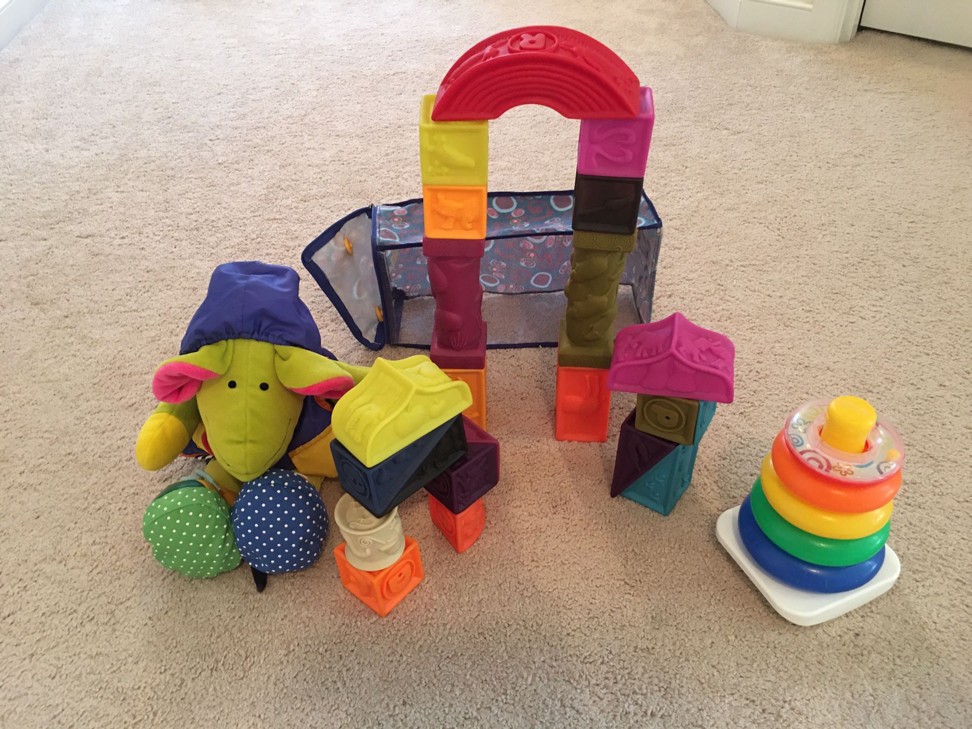 B. Toys Elemenosqueeze A to Z Architectural Soft Blocks, Learn to Dress Mouse, and Rock-a-Stack Toy