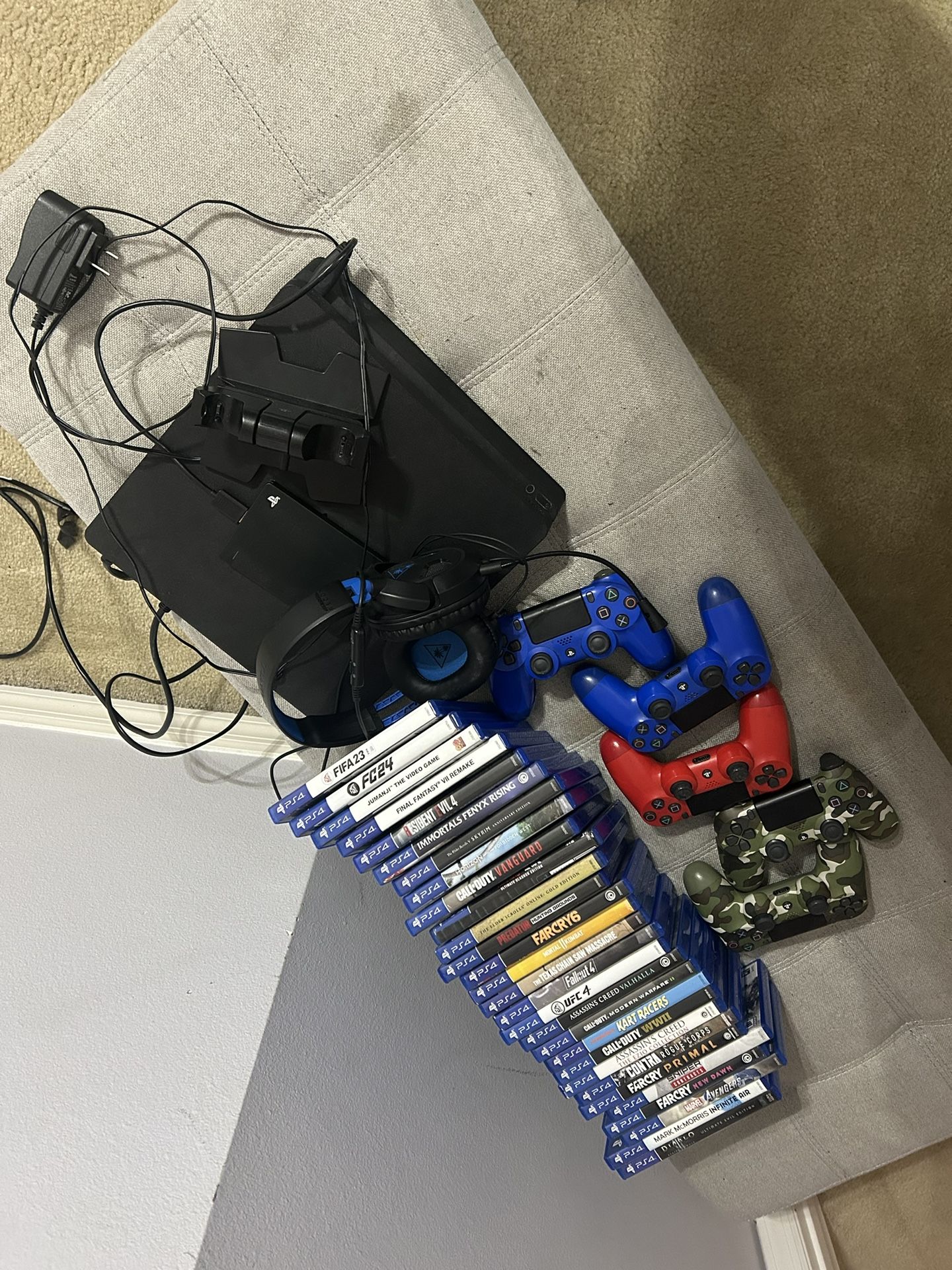 ps4 with charging station, 5 controllers, headphones, and 29 different games
