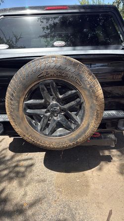 Rear hitch spare tire carrier